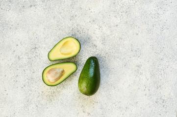 Avocado cut. Fresh avocado on stone background.