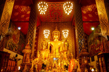 Fototapeta na wymiar Beautiful Big Golden Buddha is enshrined in the church of Phra That Hariphunchai,Lamphun,Thailand,ASIA.