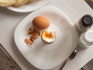 Traditional nutritious breakfast of soft-boiled eggs with buttered bread