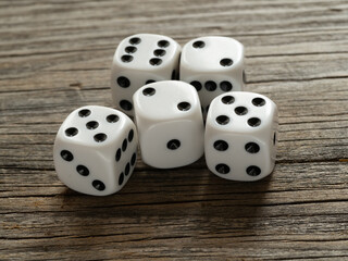 White dice thrown randomly on old boards