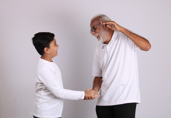 Happy Indian grandfather and grandson spending quality time