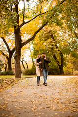 Fototapeta premium Young couple walking in the autumn park