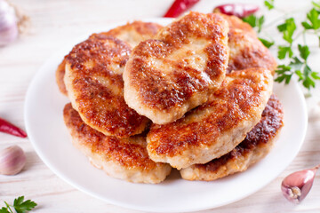 Chicken patties or fish cutlets fried in breadcrumbs on the table