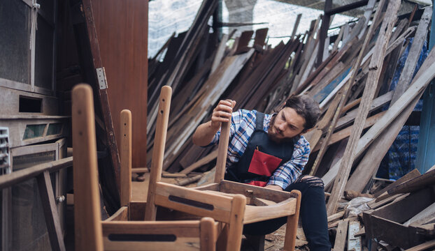 Carpenter man cutting wood with saw. craftsman working workshop factory industry.  Capenter worker with mask protection.