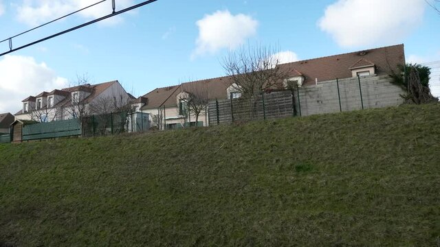 Suburban Neighborhood Town Row Houses. POV View out  of RER Train Window. Paris Suburbs near Railway. Ile-de-France Europe. 2020. 2x Slow motion 60 fps 4K