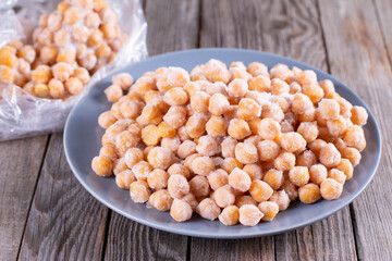 Boiled chickpeas. Putting in a transparent plastic bag for freezing. . Process of making frozen chickpea. It is called 