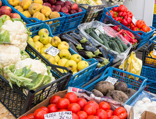 Fresh fruits and vegetables on display in a market in Bucharest. with prices in romanian currency