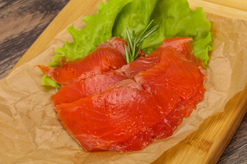 Sliced salmon fillet served rosemary