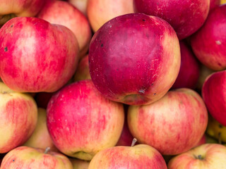 Fototapeta na wymiar Fresh organic red apples on display at the market. Freshly picked fruits.
