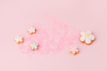 Fototapeta na wymiar Flower shape cookies anf confettic on pink pastel background. Tender holiday concept - Saint Valentine, Woman, Mother day, Easter, spring time banner for your site. copy space, cute flyer