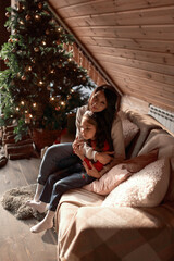 Obraz premium Mum with a daughter decorate christmas tree. Isolated.
