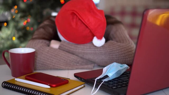 female studentin santa hat makes conference video call on laptop computer talks with web tutor, online teacher in remote webcam chat on screen. Distance education class concept.