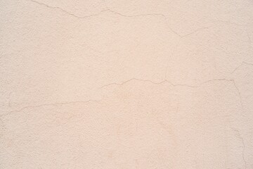 old plastered wall surface with thin cracks for rough textured background or pale wallpaper