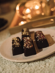 Vegan chocolate candies at a plate. Delicious healthy dessert. 