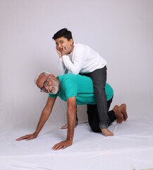Happy Indian grandfather and grandson spending quality time