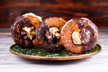 Three homemade chocolate covered marshmallow crackers (s'more ) on green in dots plate