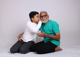 Happy Indian grandfather and grandson spending quality time