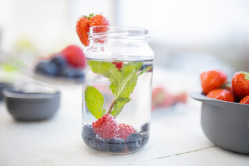 Strawberry on the edge of a mint and berries drink