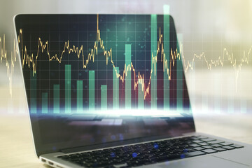 Double exposure of abstract creative financial diagram on modern laptop background, banking and accounting concept