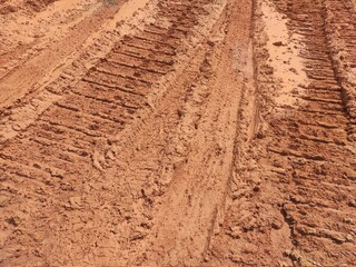 The mark of heavy vehicle tires that have gone through a muddy soil. 