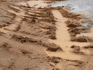The mark of heavy vehicle tires that have gone through a muddy soil. 