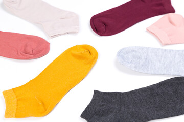 several colored new short socks on a white background, top view
