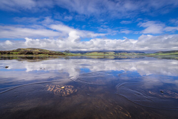 Fototapeta premium Reflection in the water of Dyrholaos estuary near cape Dyrholaey in Iceland