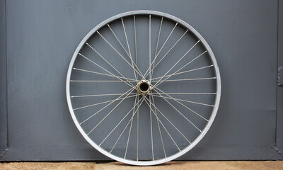 Gray bicycle disc. Bicycle wheel on a gray background. Place for text. Selective focus. - Powered by Adobe
