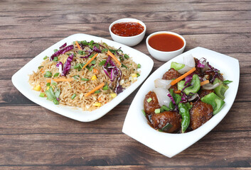 Healthy and tasty veg fried rice and paneer chilly dry with tomato sauce served in bowl over a rustic wooden background, Indian cuisine, selective focus