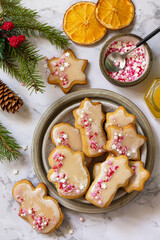 Christmas baking. Homemade gingerbread cookies with glaze on a marble countertop. Top view flat lay.