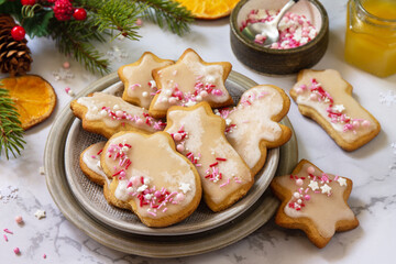 Christmas pastries. Homemade gingerbread cookies with glaze on a marble countertop.