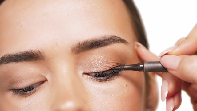 fashion woman makeup beauty eyes. Eye makeup - drawing arrows with a liner.