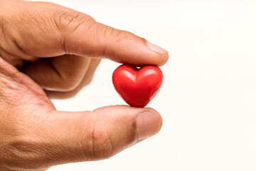 Fototapeta premium Little Heart in hand of old man. heart disease, Heart Disease Prevention, Health care 