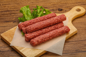 Raw beef sausages with spices
