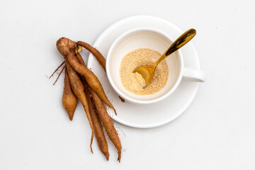 The finger root or Chinese's Ginger is herbal beverage in thailand. white cup and golden spoon with herb in picture.