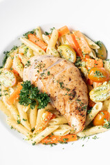 fried chicken breast with penne and saute vegetables pasta dish