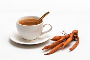 The finger root or Chinese's Ginger is herbal beverage in thailand. white cup and golden spoon with herb in picture.
