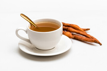 The finger root or Chinese's Ginger is herbal beverage in thailand. white cup and golden spoon with herb in picture.