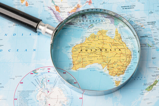 Bangkok, Thailand - November 01, 2020 Australia, Magnifying glass close up with colorful world map