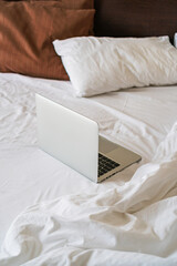 open laptop is on the bed