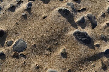 Fototapeta na wymiar rocks on sand