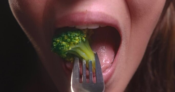 Young Woman Mouth Eating Broccoli