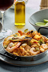 Classic valencian paella from rice with seafood and vegetables - traditional dish of spanish cuisine and sangría
