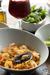 Classic valencian paella from rice with seafood and vegetables - traditional dish of spanish cuisine and sangría