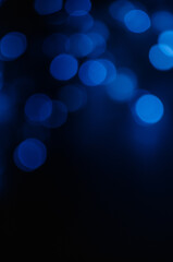 Abstract pattern of blue bokeh lights on black background © Annuitti