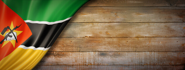 Fototapeta na wymiar Mozambique flag on vintage wood wall banner