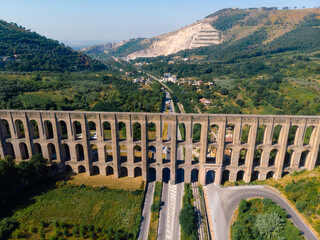 Aerial view. The Aqueduct of Vanvitelli, Caroline. Valle di Maddaloni, near Caserta Italy. 17th century. Large stone structure for transporting water. Viaduct. - obrazy, fototapety, plakaty