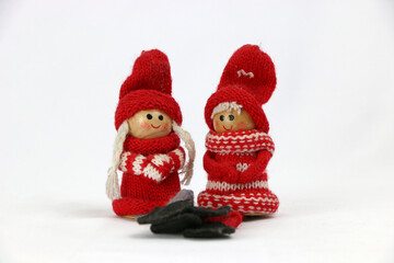 two Christmas wooden dolls with red hat.