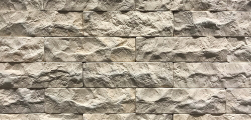 Grey brick wall texture background. Tiled with cope space
