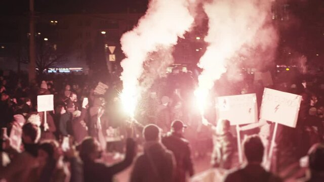 Women's strike in Poland. Fighting against abortion ban. Red smoke and flares